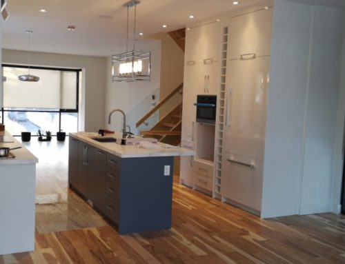 Contemporary Kitchen with High Gloss White Doors, Fly Out Island Countertop, and Vertical Wine Storages