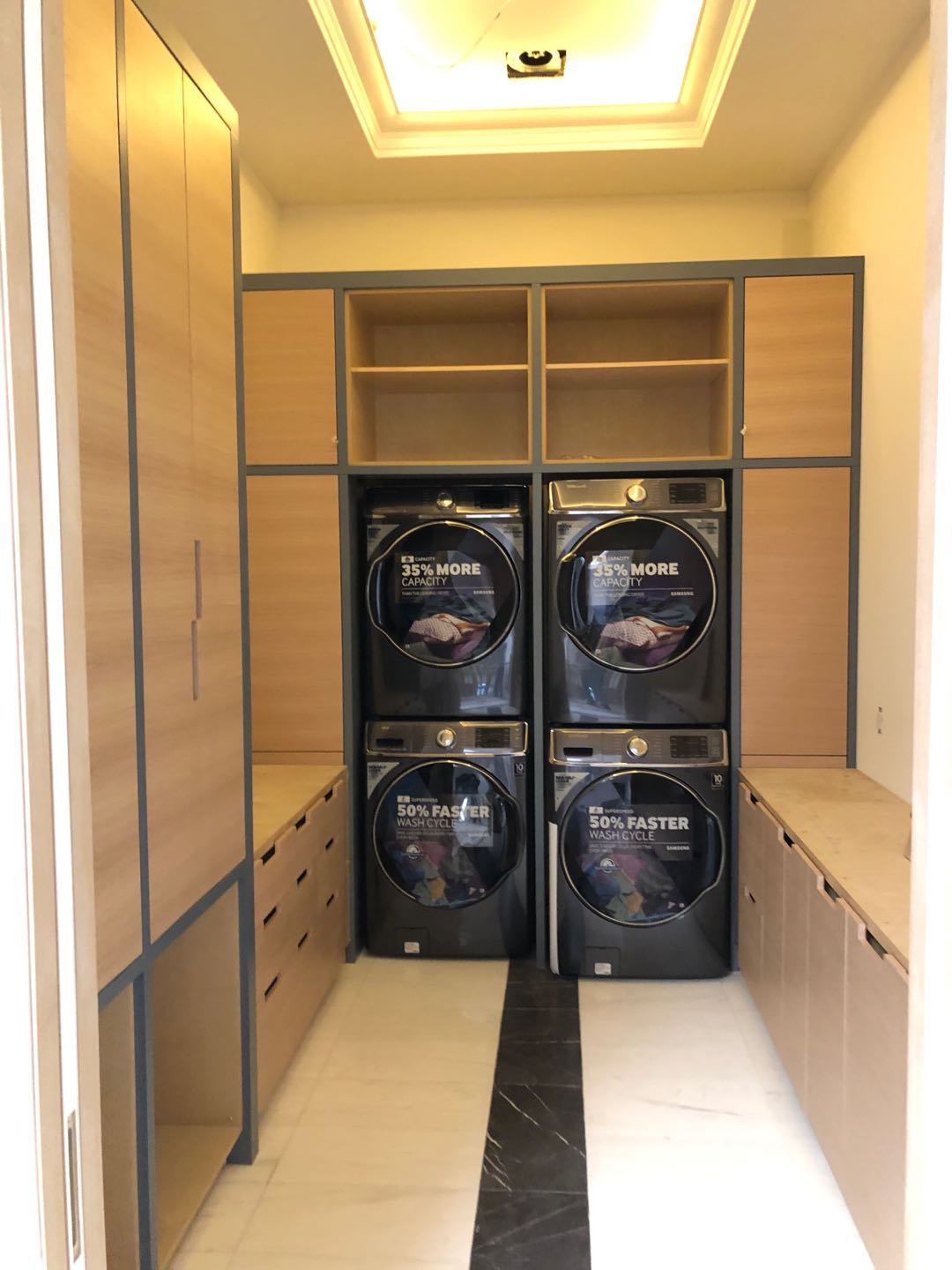 Laundry Room with Natural Wood Finish Cabinetry And Black Lining
